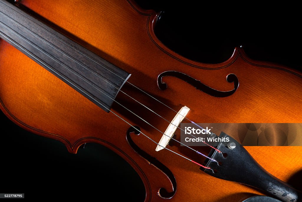 Isolated violin on black background Violin stand on table with nice reflection and isolated on black background Antique Stock Photo