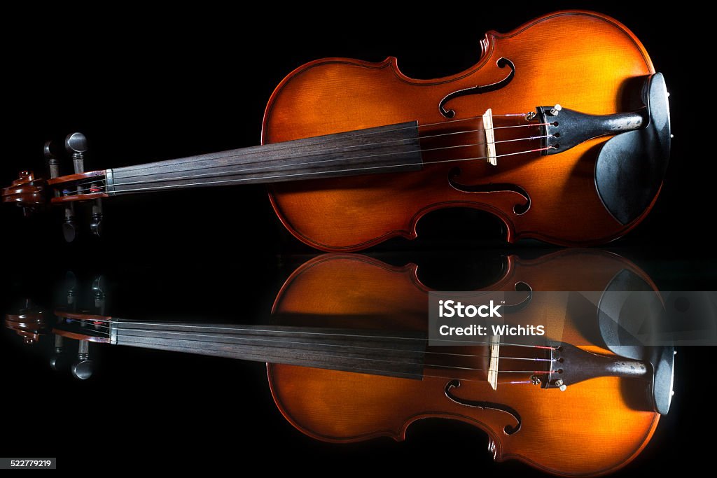 Isolated violin on black background Violin stand on table with nice reflection and isolated on black background Antique Stock Photo