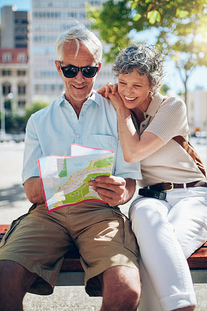 istock Mature tourist reading city map 522779672