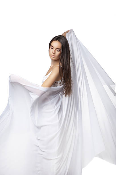 istock Young woman dancing in gorgeous white dress 522779876