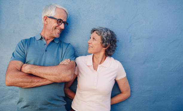 istock Portrait of affectionate mature couple against a blue wall 522779984