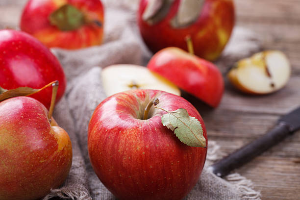 istock Fresh red apples on wooden background 522780212