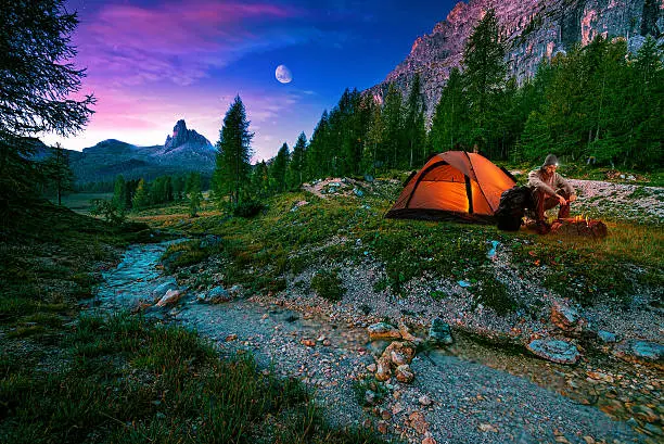 Photo of Mystical night landscape, in the foreground hike, campfire and tent