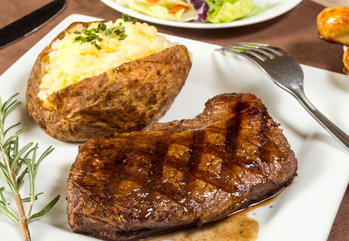 grilled sirloin steak dinner with baked potato