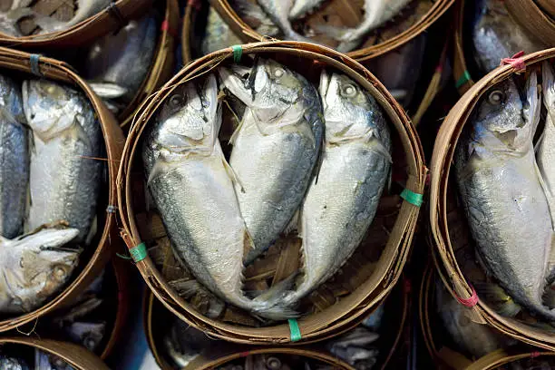 Photo of Steaming mackerel in bamboo basket at the market