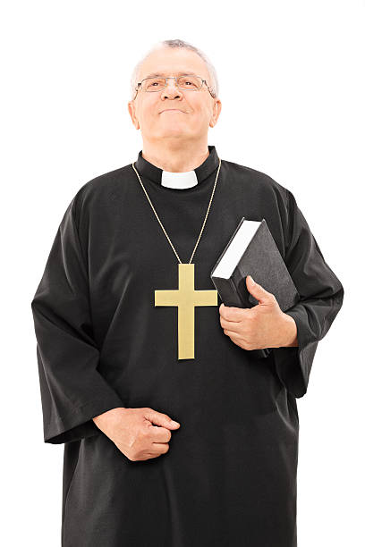 istock Mature priest holding a bible and looking up 522781833