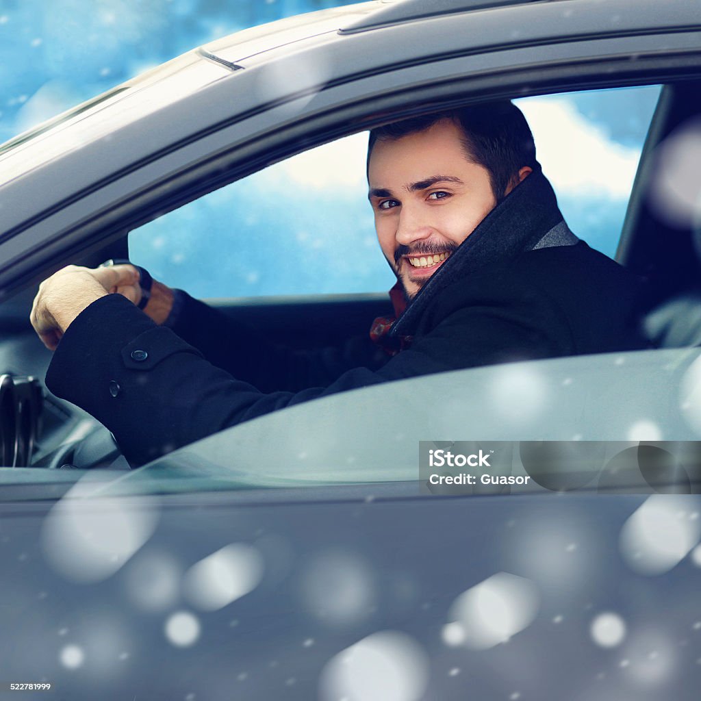 Transportation, winter and people concept - closeup happy smilin Transportation, winter and people concept - closeup happy smiling man driver behind the wheel of his car Businessman Stock Photo