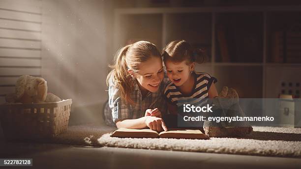 Glückliche Familie Mutter Und Tochter Lesen Sie Ein Buch Am Abend Stockfoto und mehr Bilder von Lesen