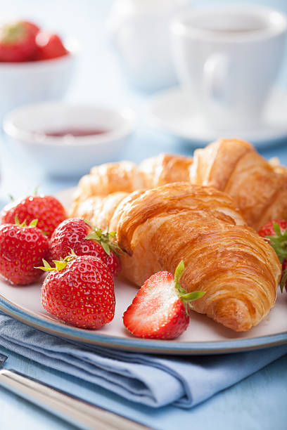 istock fresh croissants with jam and strawberry for breakfas 522782855