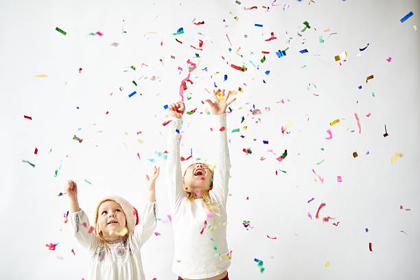 istock happy little girls under colorful snow 522783349