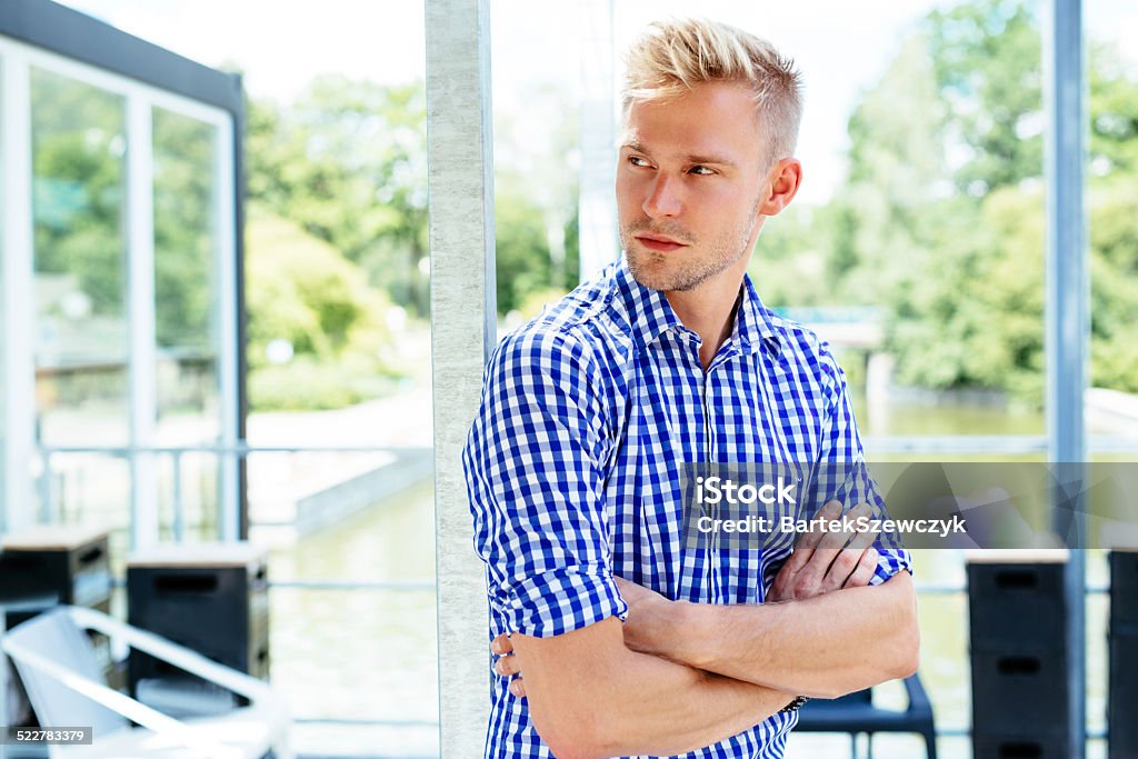 Bored with waiting Photo of a young man waiting for his friends in a park hangout Adult Stock Photo