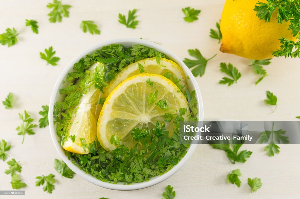 Water with parsley and lemon Water with parsley and lemon. Diet beverage Parsley Stock Photo