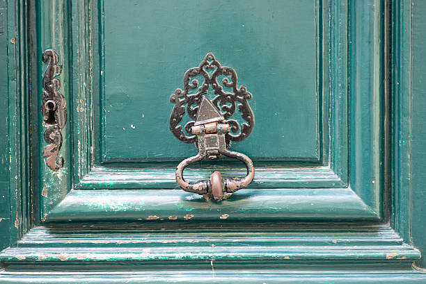 istock Bronze knocker on a green door 522786914