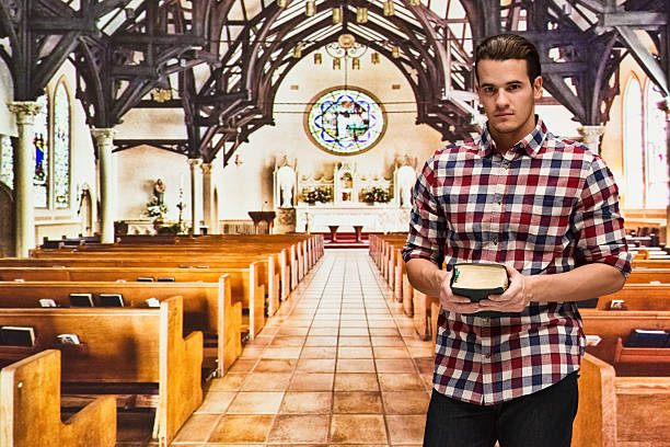 istock Man holding bible in church 522789090