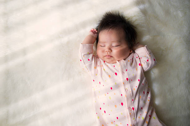 Baby girl sleeping at home. Newborn baby sleeping on a white rug baby girls photos stock pictures, royalty-free photos & images