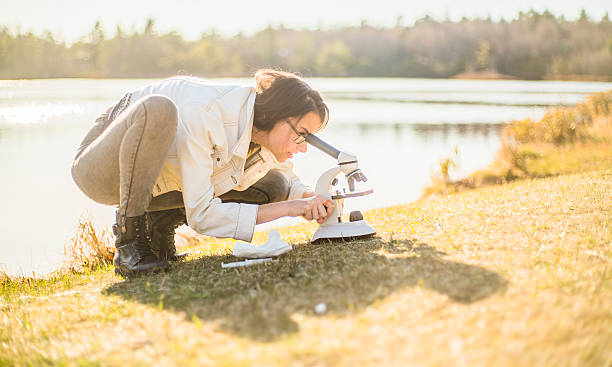 istock Teenage girl make outdoors scientific project with microscope 522789424