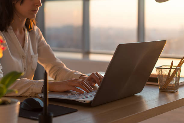 istock Side view photo of a female programmer using laptop, working 522790592