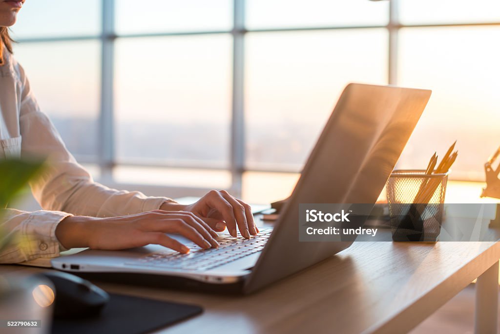 Adult businesswoman working at home using computer, studying business ideas Adult businesswoman working at home using computer, studying business ideas on a pc screen on-line E-Learning Stock Photo