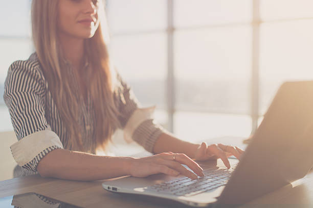 istock Female writer typing using laptop keyboard at her workplace in 522792308