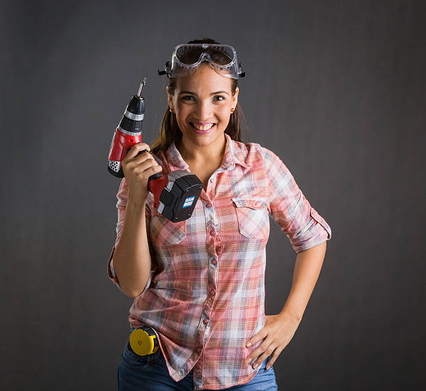 istock Beautiful woman holding a power drill 522794470
