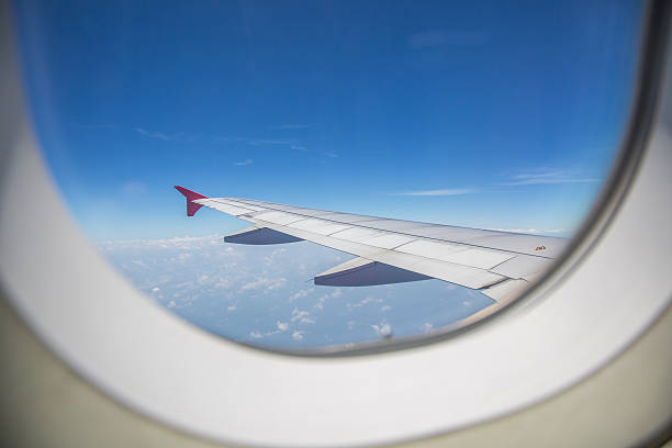 istock View through a window of an left airplane wing aircraft. 522796726