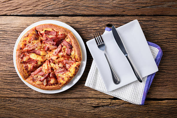 istock Delicious fresh pizza served on wooden table 522797540