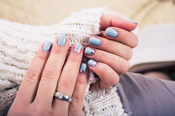 istock beautiful manicure. Gel polish coating in blue, embossing. 522801390