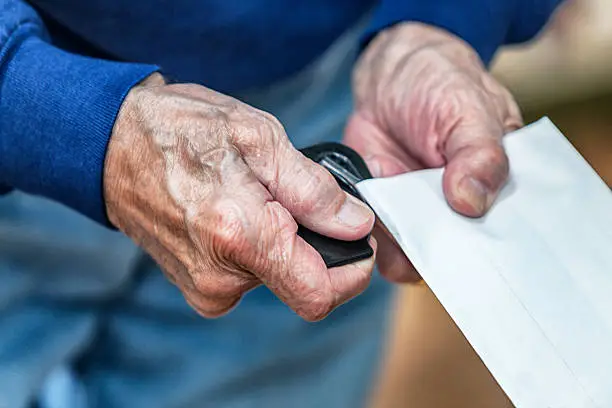 Photo of Senior Adult Man Hands Using Letter Envelope Opener