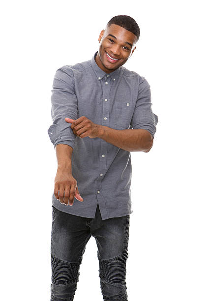 African american man smiling and rolling up sleeves Portrait of a african american man smiling and rolling up sleeves rolled up sleeves stock pictures, royalty-free photos & images