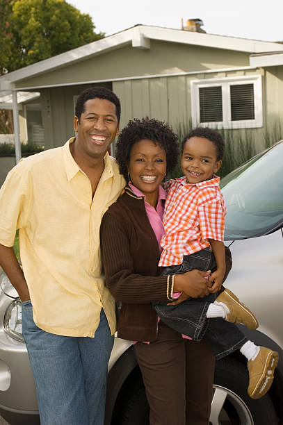 istock Family Standing in Front of Home 522804447