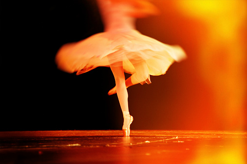 Artistic shot of ballerina in motion during a school performance. Shot with Canon 5D, light leak and Lomo effect applied.