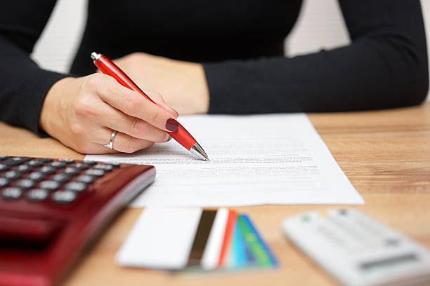 woman is reading bank notice about credit card spending stock photo