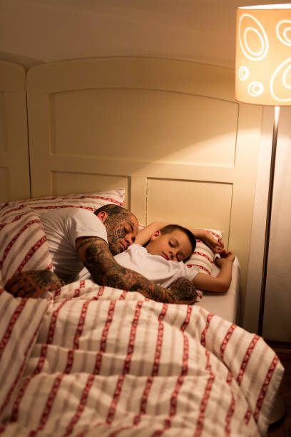 istock Father and son sleeping in the bed. 522806246