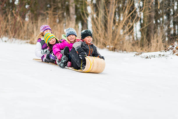 istock Children Sledding on Toboggan Hill 522806443