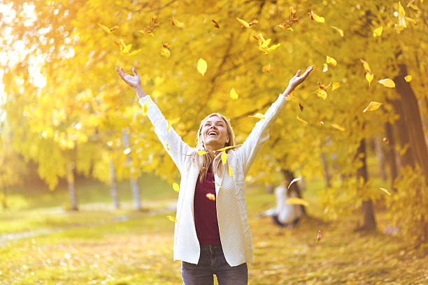 istock Leaf fall, happy woman in the autumn park 522815551