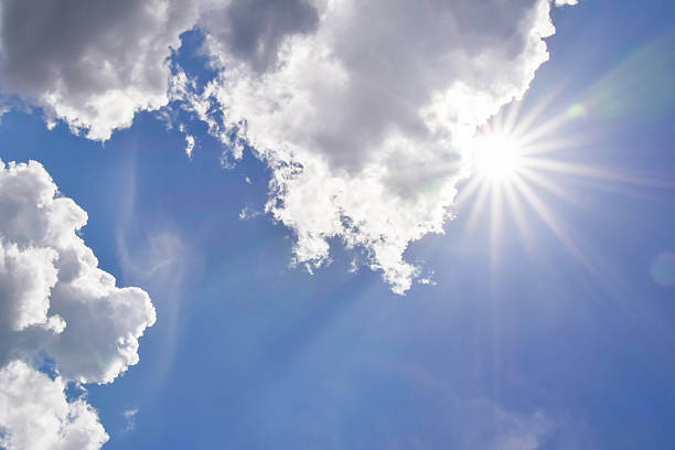 istock Realistic shining sun with lens flare. Blue sky with clouds 522815663