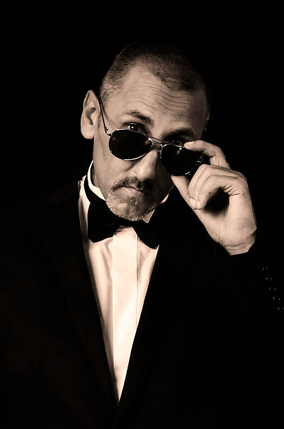 istock Stylish man in suit and bow tie wearing sun glasses 522817077
