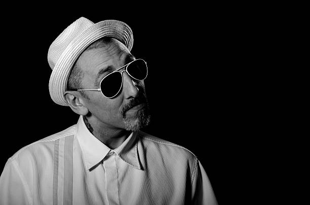 istock stylish manwearing white hat sun glasses,black background 522817547
