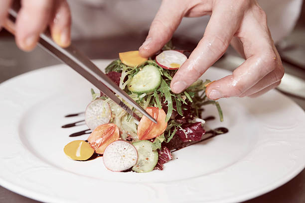 Chef is decorating appetizer, toned image