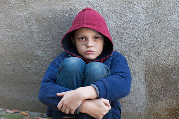 istock homeless boy leaned against the wall 522820675