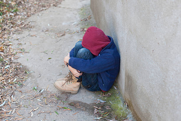 istock homeless boy leaned against the wall 522820687