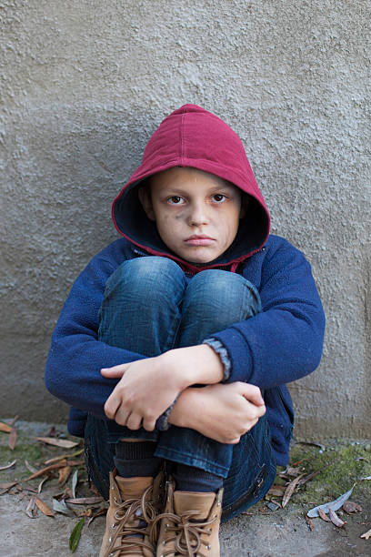 istock homeless boy leaned against the wall 522820697