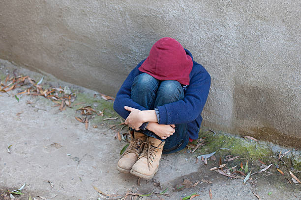 istock homeless boy leaned against the wall 522820699