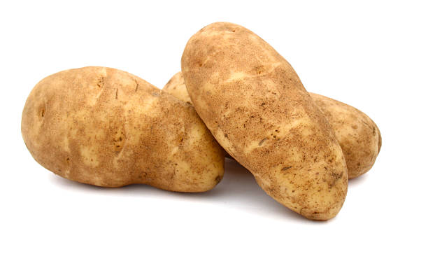russet potato A russet potato (Idaho potato) raw potato stock pictures, royalty-free photos & images