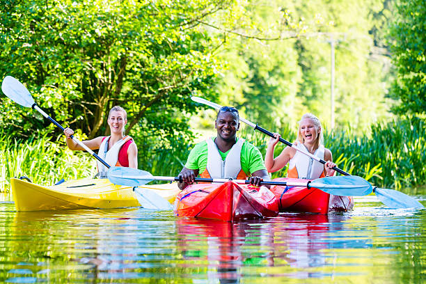 istock Friends paddling with canoe on forest river 522821687