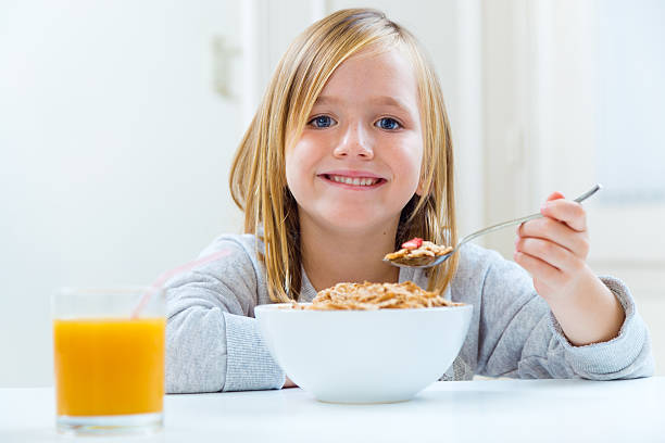 istock Beautiful child having breakfast at home. 522834365