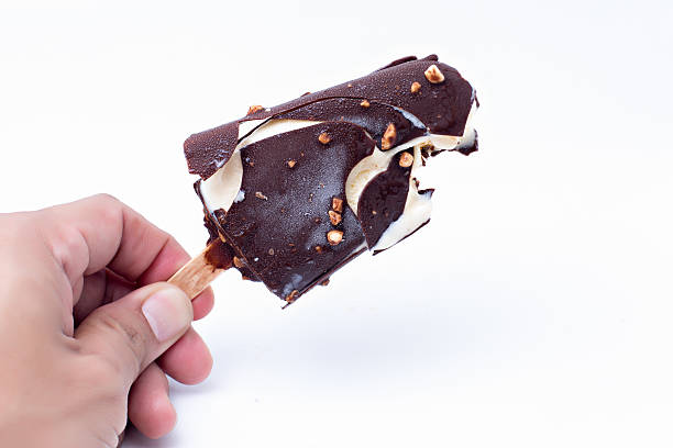 istock Holding ice Cream chocolate popsicle, isolated on white 522835457