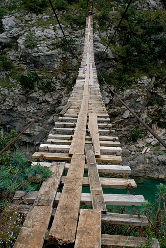 Very old wooden rope bridge above canyon in montenegro (balkan).