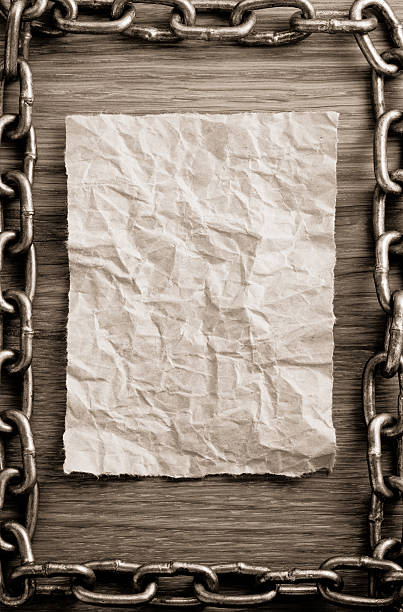 istock metal chain and old paper 522837413