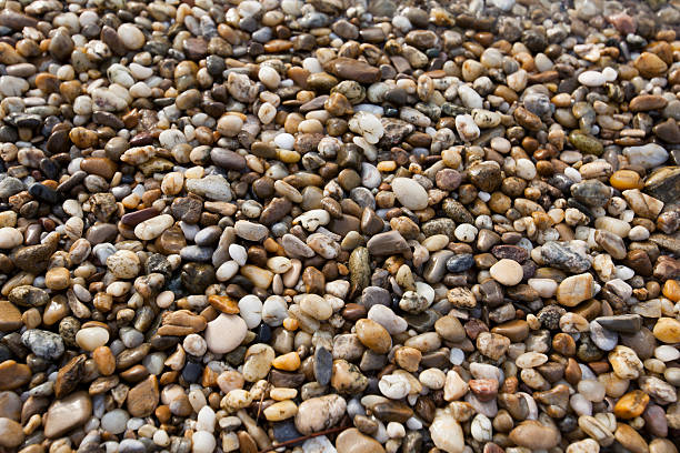 istock Brown pebble stone floor background seamless and texture 522839019